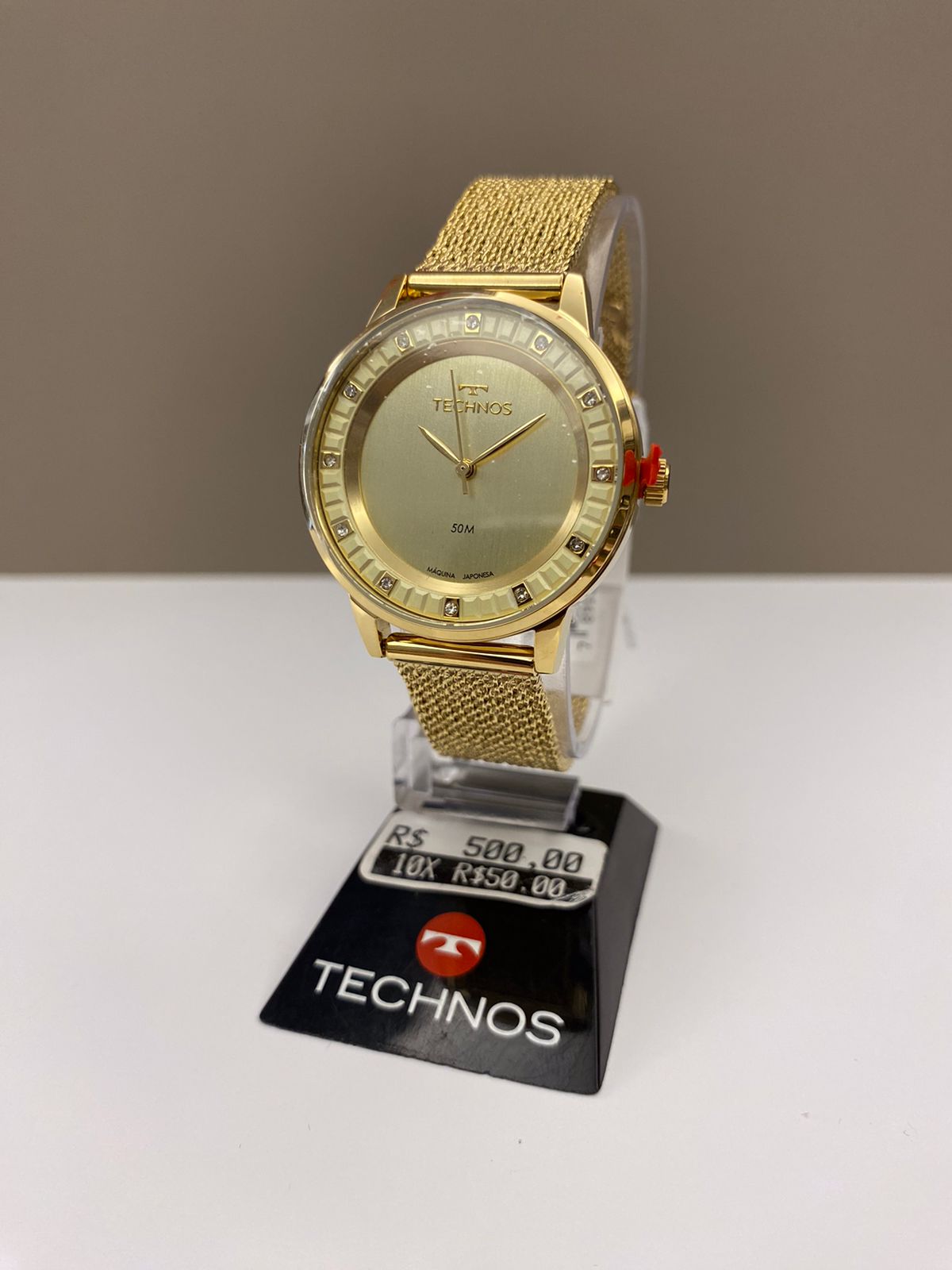 Relógio Technos Feminino Dourado Minimalista Visor Champanhe com Cristais Pulseira Milanesa Maquinário Japonês Aço Inoxidável Á Prova d'água 203MZC/1D  