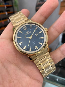 Relógio Technos Golf Dourado verde Masculino Com calendário a prova d´água Aço inox 2115NBF/1A