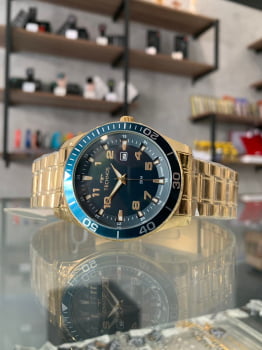 Relógio Technos Dourado Masculino com Calendário Visor Azul Maquinário Japonês Aço Inoxidável Á Prova d´água 2115MQLS/4A